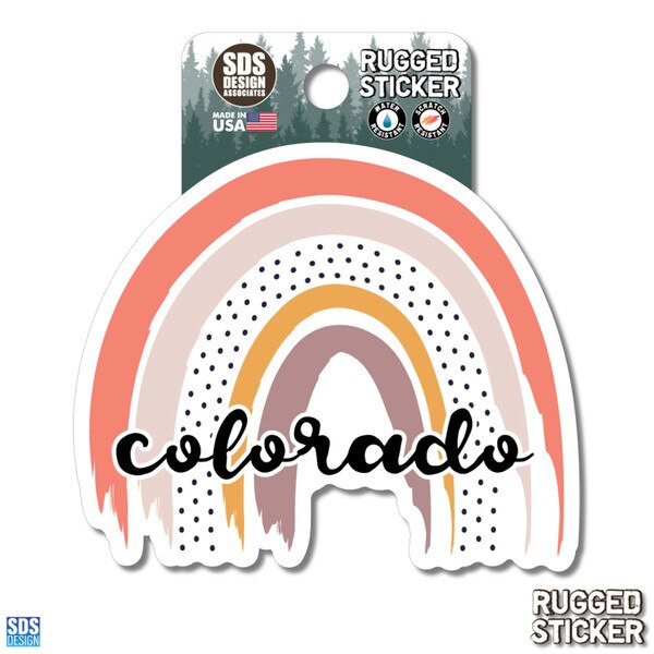 Rugged sticker featuring a hand-drawn rainbow in soft pink, orange, and yellow tones with black polka dots and the word “Colorado” in a bold black script.